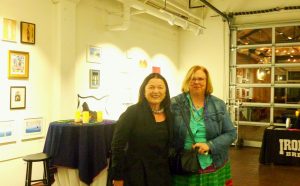 (L to R:) Erika Torri and Carol Buckley in the gallery of Athenaeum Art Center.