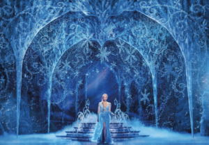 Elsa stands in the Ice Palace midstage.